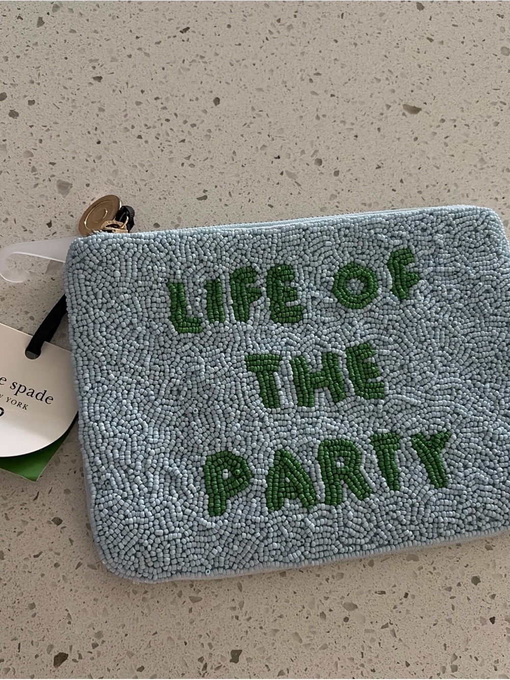 kate spade light blue beaded pouch with green lettering